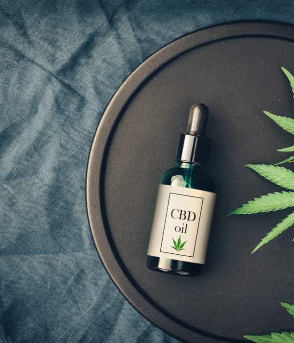 Medical marijuana and cannabis products CBD oil, hemp leaves on a dark background. Flat lay, copy space Mockup
